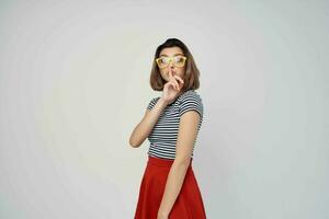 woman wearing yellow glasses striped t-shirt cropped view light background photo