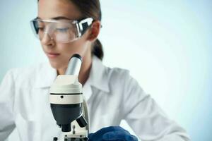 woman laboratory assistant microscope diagnostics research science photo