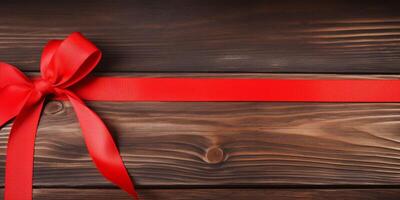 red ribbon on a wooden table photo