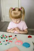 A blogger girl makes a felt craft for Valentine's Day in the shape of a heart. The concept of children's creativity and handmade. photo