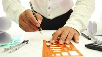 Architect hands drawing circle on large format paper at modern office, man working with ruler and pencil on project, selective focus video