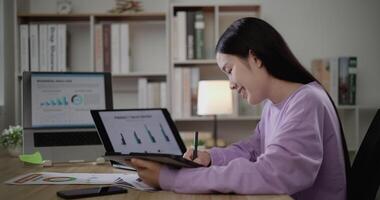 Footage of young Asian woman, freelance data scientist work remotely at home coding programming on Big data mining, AI data engineering, Female writes notes on tablet. IT Technician. Telework concept. video