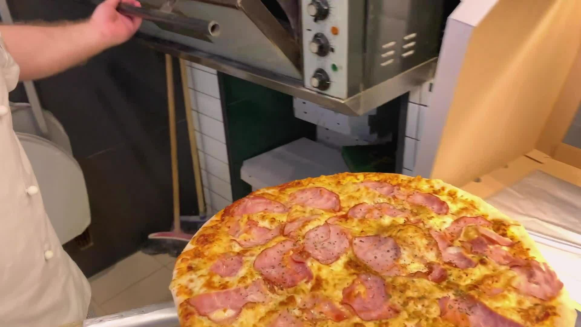 Pizza Making of process. Putting to the oven. Baking pizza in