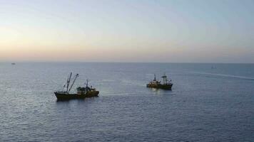 Fishing Trawlers at Sea Seen From the Air at Sunrise video