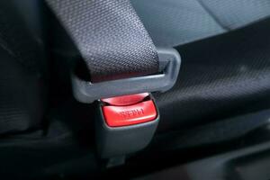 selective focus to press button on safety belt in car. soft focus. under exposure photo