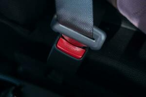 selective focus to press button on safety belt in car. soft focus. under exposure photo