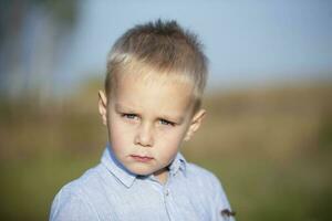 Portrait of a blond and blue-eyed three-year-old boy. photo