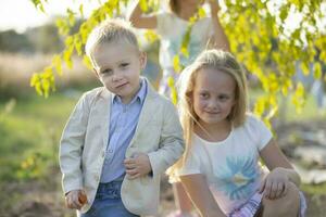 Little boy in a suit on the background of his sister. photo