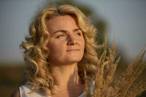 Beautiful middle-aged woman on the background of the field. photo