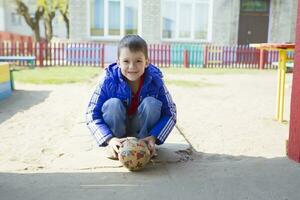 Belarus, Gomel, May 30, 2019. An open day in a kindergarten. Preschool boy with a ball. photo