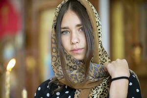 July 15, 2020 Belarus, city of Gomil. City church. Beautiful girl in a headscarf on a church background. photo