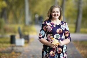 Happy girl in autumn park with leaves. photo