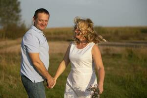 Beautiful middle-aged couple in love on the background of nature. photo