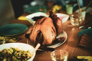 Thanksgiving dinner cooked turkey on wooden table photo