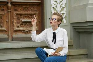 pretty woman with a book in his hands outdoors reading education photo