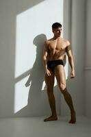 man with a pumped up body in black panties posing photo