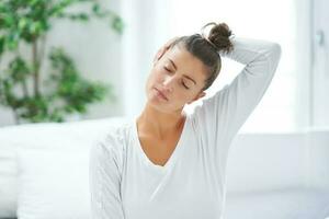 Nice female in bed relaxing or doing yoga photo