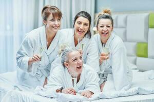 Girls with wine at spa party in the hotel photo