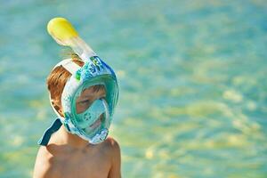 Portrait of young boy in snorkeling mask photo