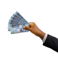 Black hand with suit holding New Jordanian Dinar notes isolated on transparent background, 3d rendering png