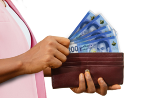 fair Female Hand Holding brown Purse With Moroccan dirham notes, hand removing money out of purse isolated on transparent background png