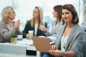 Picture of woman holding laptop on business meeting photo