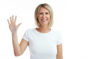 Picture of blonde woman over back isolated background counting on fingers photo