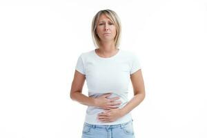 Picture of blonde woman over back isolated background with stomach problem photo