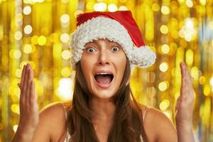 Woman over gold background making funny faces photo