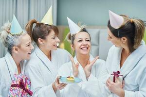 Picture of four girls in bathrobe having spa birthday party photo