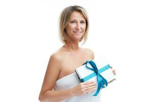 Picture of nice blonde woman holding gift or voucher photo