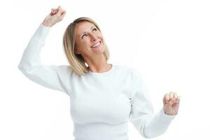 Picture of blonde woman happy dancing isolated over white background photo