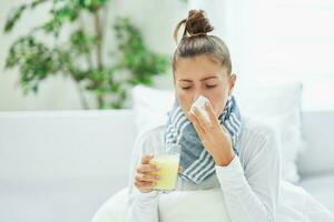 Young brunet woman sick in the bed with medicine photo