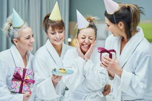 Picture of four girls in bathrobe having spa birthday party photo