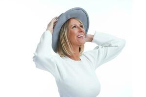 Picture of blonde woman isolated over white background wearing hat photo