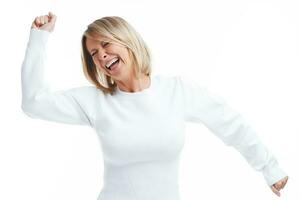 Picture of blonde woman happy dancing isolated over white background photo