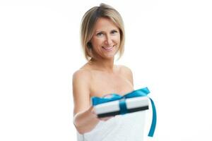 Picture of nice blonde woman holding gift or voucher photo