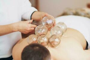 A picture of a man having cupping therapy photo