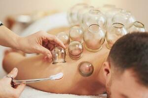 A picture of a man having cupping therapy photo