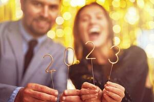 Couple at new year eve party with 2023 sparklers photo