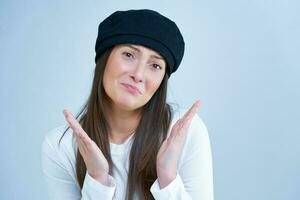 Isolated picture of brunette woman on white background wearing hat photo