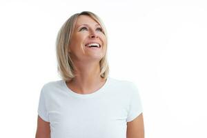 Picture of blonde woman over back isolated background making happy faces photo