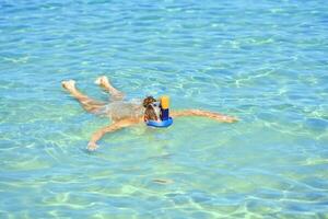 Woman snorkeling in water of Red Sea photo