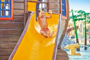 Picture of young boy playing in outdoor aqua park photo