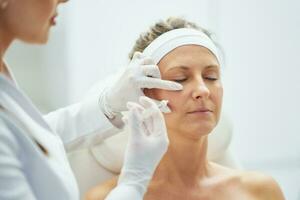 A scene of medical cosmetology treatments botulinum injection. photo