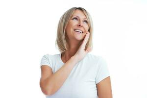 Picture of blonde woman over back isolated background making happy faces photo