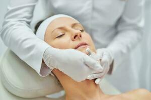 A scene of medical cosmetology treatments botulinum injection. photo