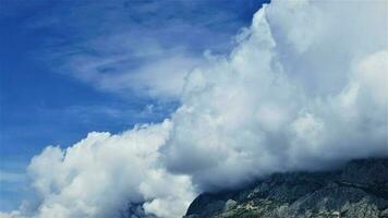 Mountain and big white clouds horizon photo