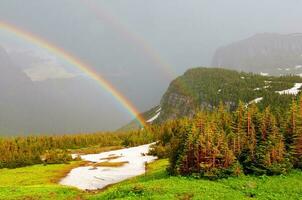 Double rainbow in a mountain storm photo