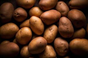 Ripe potatoes on a wooden table. Selective focus, toned, illustration. photo